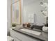 Well-lit bathroom featuring a modern vanity with gray countertop, a large mirror, and stylish decorative accents at 3071 Pink Gerbera Sq, Plant City, FL 33566
