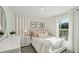 Bright bedroom with stylish wall decor, plush bedding, and plenty of natural light at 3071 Pink Gerbera Sq, Plant City, FL 33566