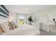 Bright bedroom featuring a view of the lake and an ensuite bathroom with a walk-in closet at 3071 Pink Gerbera Sq, Plant City, FL 33566