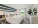 Bright bedroom featuring a large window with a view of a lake with a stylish white dresser at 3071 Pink Gerbera Sq, Plant City, FL 33566