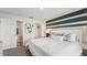 This bedroom features a stylish accent wall, ensuite bathroom, and walk-in closet for optimal convenience at 3071 Pink Gerbera Sq, Plant City, FL 33566