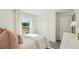 Sunlit bedroom with neutral tones, closet access, and bright window views at 3071 Pink Gerbera Sq, Plant City, FL 33566