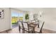 Stylish dining room featuring a modern table, chic decor, and a sliding door for outdoor access at 3071 Pink Gerbera Sq, Plant City, FL 33566