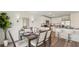 Open-concept dining area with modern table and chairs, seamlessly connected to the kitchen and living spaces at 3071 Pink Gerbera Sq, Plant City, FL 33566