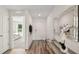 Functional hallway with coat hooks, a decorative mirror, a console table and durable wood-look floors at 3071 Pink Gerbera Sq, Plant City, FL 33566