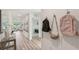 Inviting hallway featuring stylish flooring, elegant decor, and views into the bright, open living space at 3071 Pink Gerbera Sq, Plant City, FL 33566
