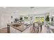 Open living area with modern kitchen, dining space, and scenic backyard views at 3071 Pink Gerbera Sq, Plant City, FL 33566
