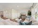 Bright living room featuring a comfortable white sectional, modern furniture, and plenty of natural light at 3071 Pink Gerbera Sq, Plant City, FL 33566