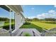 Relax on the back patio while enjoying beautiful views of the green backyard and glistening lake at 3071 Pink Gerbera Sq, Plant City, FL 33566