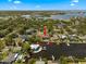 Aerial view showcasing a waterfront home with a pool and canal access for boating enthusiasts at 316 Hillpoint Dr, Palm Harbor, FL 34683