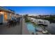Large outdoor deck with dining area overlooking the pool and waterfront at 316 Hillpoint Dr, Palm Harbor, FL 34683