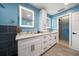 Bright bathroom features double vanity, with white cabinets and a walk-in shower at 316 Hillpoint Dr, Palm Harbor, FL 34683