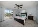 Comfortable bedroom with access to a private deck, ceiling fan, and neutral carpet at 316 Hillpoint Dr, Palm Harbor, FL 34683