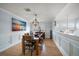 Dining area features hardwood floors, decorative wainscotting, and an elegant chandelier at 316 Hillpoint Dr, Palm Harbor, FL 34683