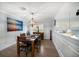 Dining area features hardwood floors, decorative wainscotting, and an elegant chandelier at 316 Hillpoint Dr, Palm Harbor, FL 34683
