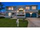 Charming two-story home with blue exterior, a manicured lawn and a two-car garage at 316 Hillpoint Dr, Palm Harbor, FL 34683