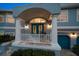 Close up of the front porch columns and blue doors with transom window allowing lots of natural light at 316 Hillpoint Dr, Palm Harbor, FL 34683
