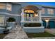 A charming front porch is adorned with plants, stone steps, and striking blue doors with white trim at 316 Hillpoint Dr, Palm Harbor, FL 34683