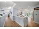 Bright and open kitchen with a white quartz island, white cabinetry, and stainless steel appliances at 316 Hillpoint Dr, Palm Harbor, FL 34683