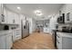 Spacious kitchen with stainless steel appliances, white cabinets, and hardwood floors at 316 Hillpoint Dr, Palm Harbor, FL 34683