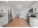 Modern kitchen features stainless steel appliances, white cabinets, and hardwood floors at 316 Hillpoint Dr, Palm Harbor, FL 34683