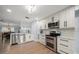 Modern kitchen features stainless appliances, white cabinets and marble countertops at 316 Hillpoint Dr, Palm Harbor, FL 34683