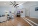Spacious living room featuring vaulted ceilings, a ceiling fan, and hardwood floors at 316 Hillpoint Dr, Palm Harbor, FL 34683