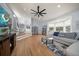 Bright living room features hardwood floors, a ceiling fan, and large windows with bench seating at 316 Hillpoint Dr, Palm Harbor, FL 34683