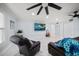 Bright living room with tile flooring, modern ceiling fan, and beach-themed decor at 316 Hillpoint Dr, Palm Harbor, FL 34683