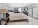 Spacious main bedroom features tile floors, a large bed, and natural light from the glass patio doors at 316 Hillpoint Dr, Palm Harbor, FL 34683