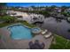A pool and hot tub overlook the canal with a dock and boat lift, perfect for enjoying waterfront living at 316 Hillpoint Dr, Palm Harbor, FL 34683
