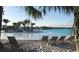 Sandy beach area with lounge chairs overlooking the clear lagoon at 32417 Welling Blade Loop, Wesley Chapel, FL 33545