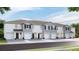 Modern townhome exteriors featuring a neutral color palette, individual garages, and well-maintained landscaping at 32417 Welling Blade Loop, Wesley Chapel, FL 33545