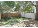 Well-maintained backyard with lush green grass, a wood fence, and mature trees, perfect for outdoor activities and relaxation at 3412 W San Juan St # A, Tampa, FL 33629