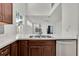 Open-concept kitchen featuring stainless steel sink, white countertop and view to backyard at 3412 W San Juan St # A, Tampa, FL 33629