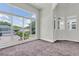 Bright living room boasts oversized windows offering outdoor views, filling the space with natural light at 3412 W San Juan St # A, Tampa, FL 33629