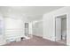 Bright loft space featuring white railings, offering a glimpse of the floor below and access to a nearby bathroom at 3412 W San Juan St # A, Tampa, FL 33629