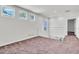 Spacious loft with carpet, white railing, and multiple windows, creating a bright and open area for relaxation or entertainment at 3412 W San Juan St # A, Tampa, FL 33629