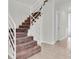 Brown carpeted stairs with white railing lead to the second floor, bathed in natural light, offering a warm and inviting transition at 3412 W San Juan St # A, Tampa, FL 33629