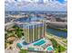 Stunning aerial view of high-rise apartment building along the river with a pool and convenient parking at 345 Bayshore Blvd # 1807, Tampa, FL 33606