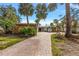 Beautiful single-story home surrounded by palm trees, and well-maintained landscape, and long paver driveway at 3830 46Th S Ave, St Petersburg, FL 33711