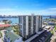 Stunning aerial view of the condominium building with balcony views of the ocean and nearby cityscape at 400 Island Way # 502, Clearwater Beach, FL 33767