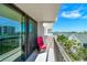 Inviting balcony space with colorful chair and a scenic view at 400 Island Way # 502, Clearwater Beach, FL 33767