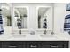 Bathroom vanity area with double sinks, brushed nickel fixtures, and decorative mirrors at 400 Island Way # 502, Clearwater Beach, FL 33767
