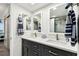Bathroom featuring double sink vanity with modern faucets, white countertops and framed mirrors at 400 Island Way # 502, Clearwater Beach, FL 33767