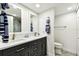 Bathroom with double sinks, white countertops, and modern fixtures, complemented by coordinated towels and a toilet area at 400 Island Way # 502, Clearwater Beach, FL 33767