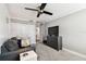 Neutral bedroom with ceiling fan, sitting area, dresser, and access to hallway and bathroom at 400 Island Way # 502, Clearwater Beach, FL 33767