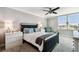 Serene bedroom with neutral tones, a ceiling fan, and a large window providing natural light and pleasant views at 400 Island Way # 502, Clearwater Beach, FL 33767