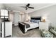Cozy bedroom featuring neutral walls, a ceiling fan, and generous closet space at 400 Island Way # 502, Clearwater Beach, FL 33767