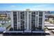 Striking front elevation of a high rise condominium building with rows of private balconies at 400 Island Way # 502, Clearwater Beach, FL 33767